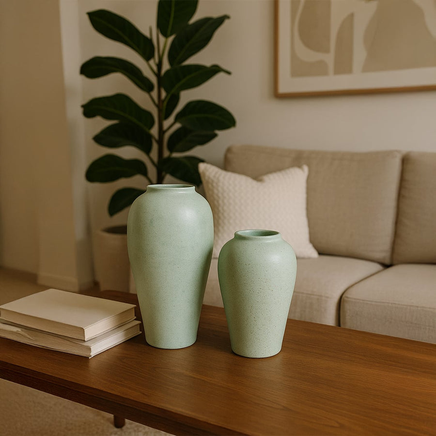 Handcrafted tall grey terracotta vase with fine textured finish placed in a cozy room creating calm organic elegance for warm natural home styling.