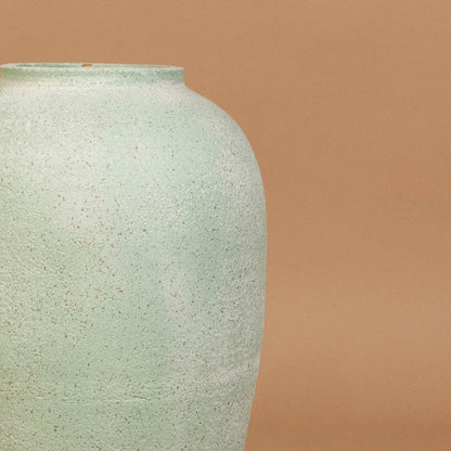 Closeup of mint green ceramic vase showing textured handcrafted finish and smooth form ideal for modern living room or hallway styling.