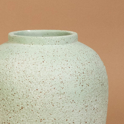 Closeup of tall grey terracotta vase highlighting its subtle grainy handcrafted texture and smooth shaping ideal for modern natural decor styling.