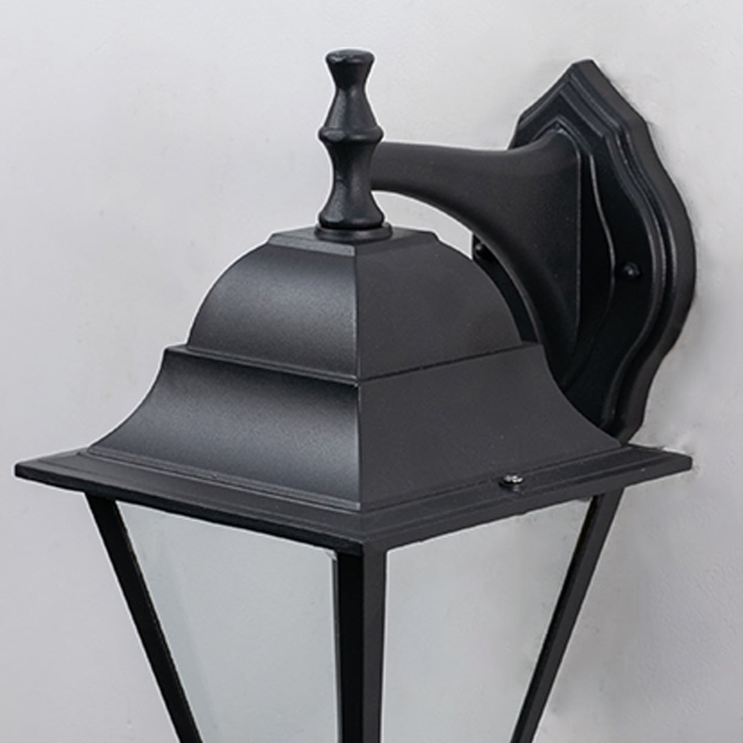 Closeup of outdoor black wall lantern showing detailed craftsmanship  smooth matte finish  and transparent glass panels.
