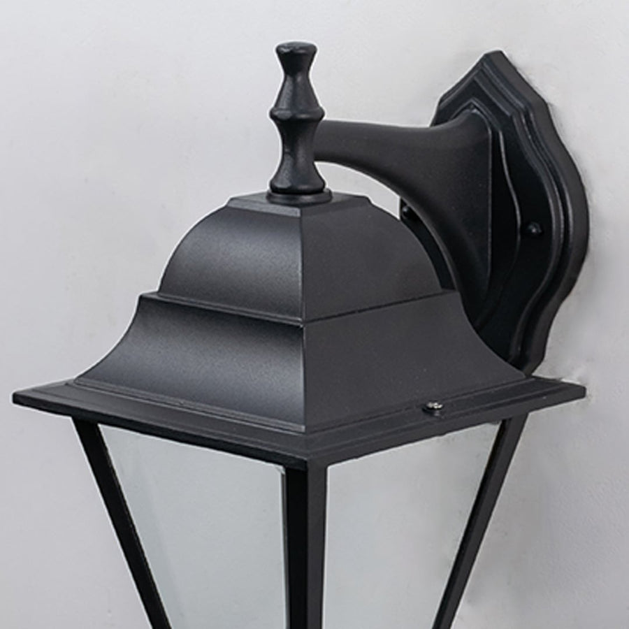 Closeup of outdoor black wall lantern showing detailed craftsmanship  smooth matte finish  and transparent glass panels.