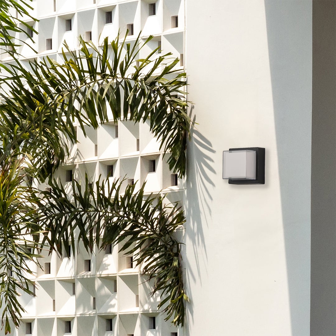 Black metal outdoor wall light lifestyle image on modern exterior wall for stylish patio lighting decor.