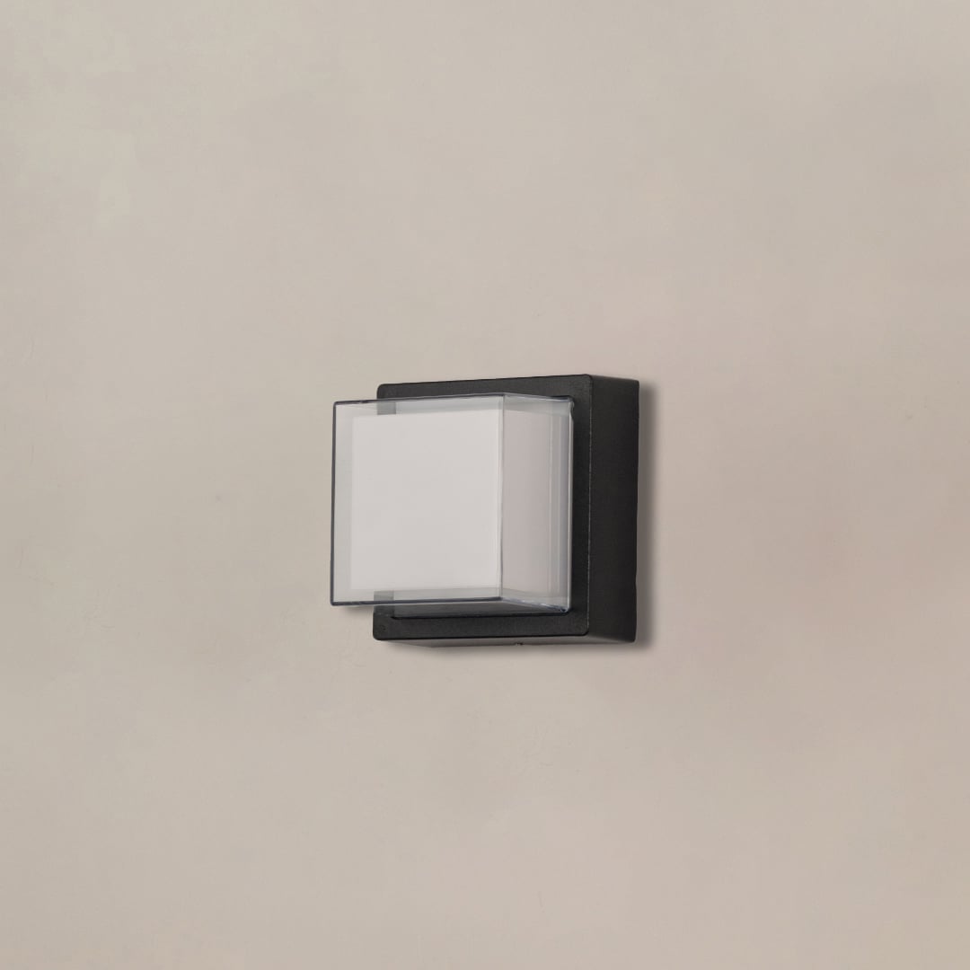 Vintage black outdoor lantern wall light on white background with decorative mount for classic patio decor.