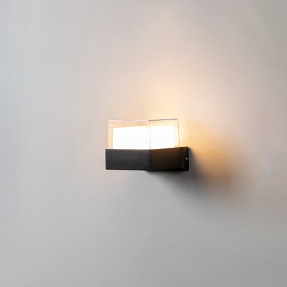 Modern black wall light with frosted glass shade glowing warmly for minimalist interior wall decor.
