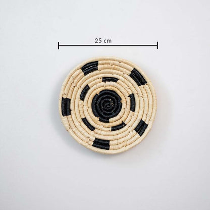 Small handcrafted round wall basket in natural and black tones showing 22 cm diameter suitable for compact wall decor use.