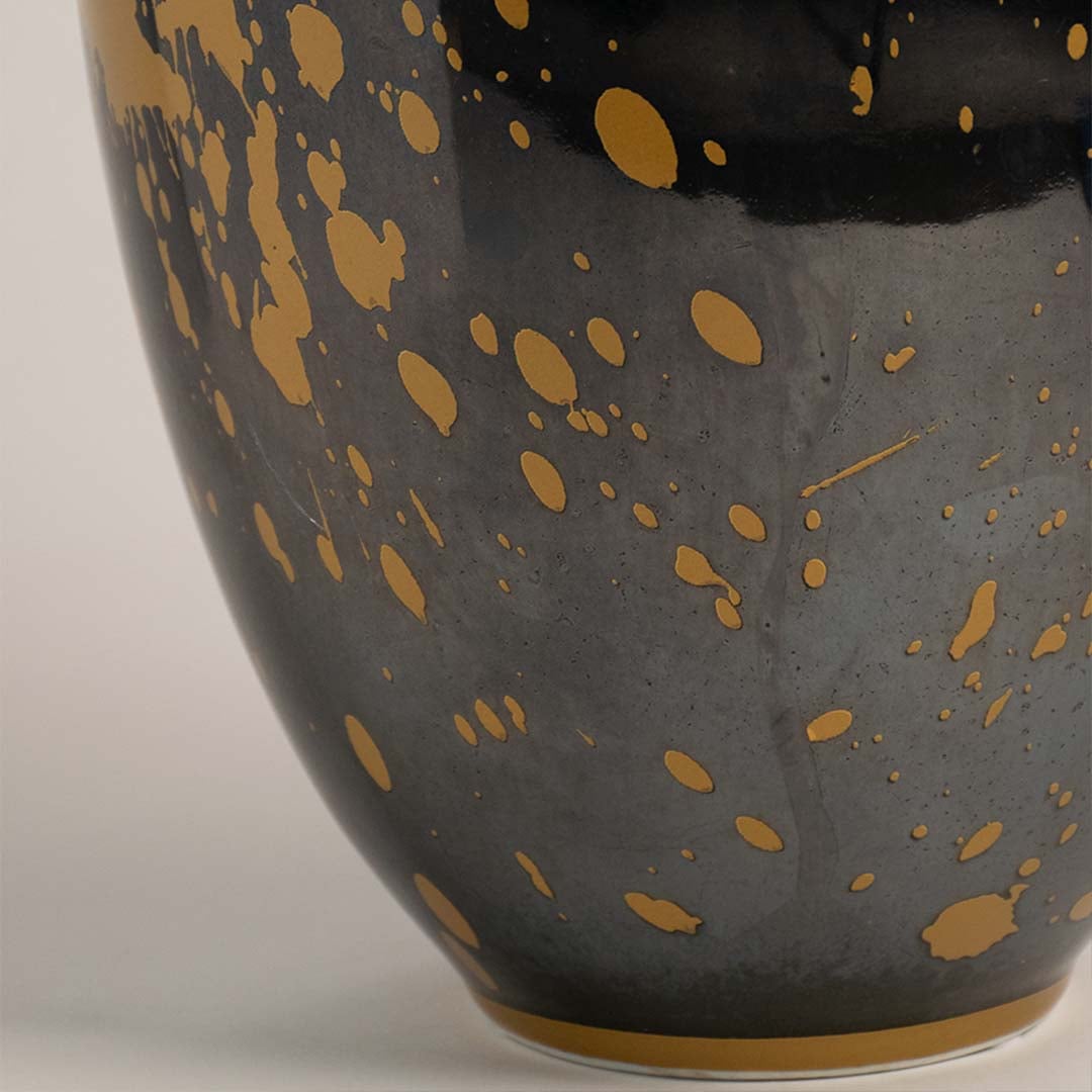 Closeup of vase neck showcasing glossy black finish with gold rim accent.