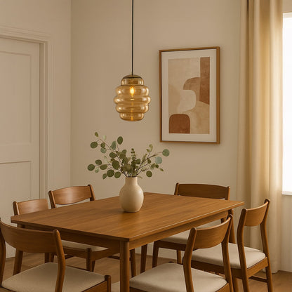 Amber ripple pendant light hanging above wooden dining table adding warm glow and modern elegance to cozy interiors.