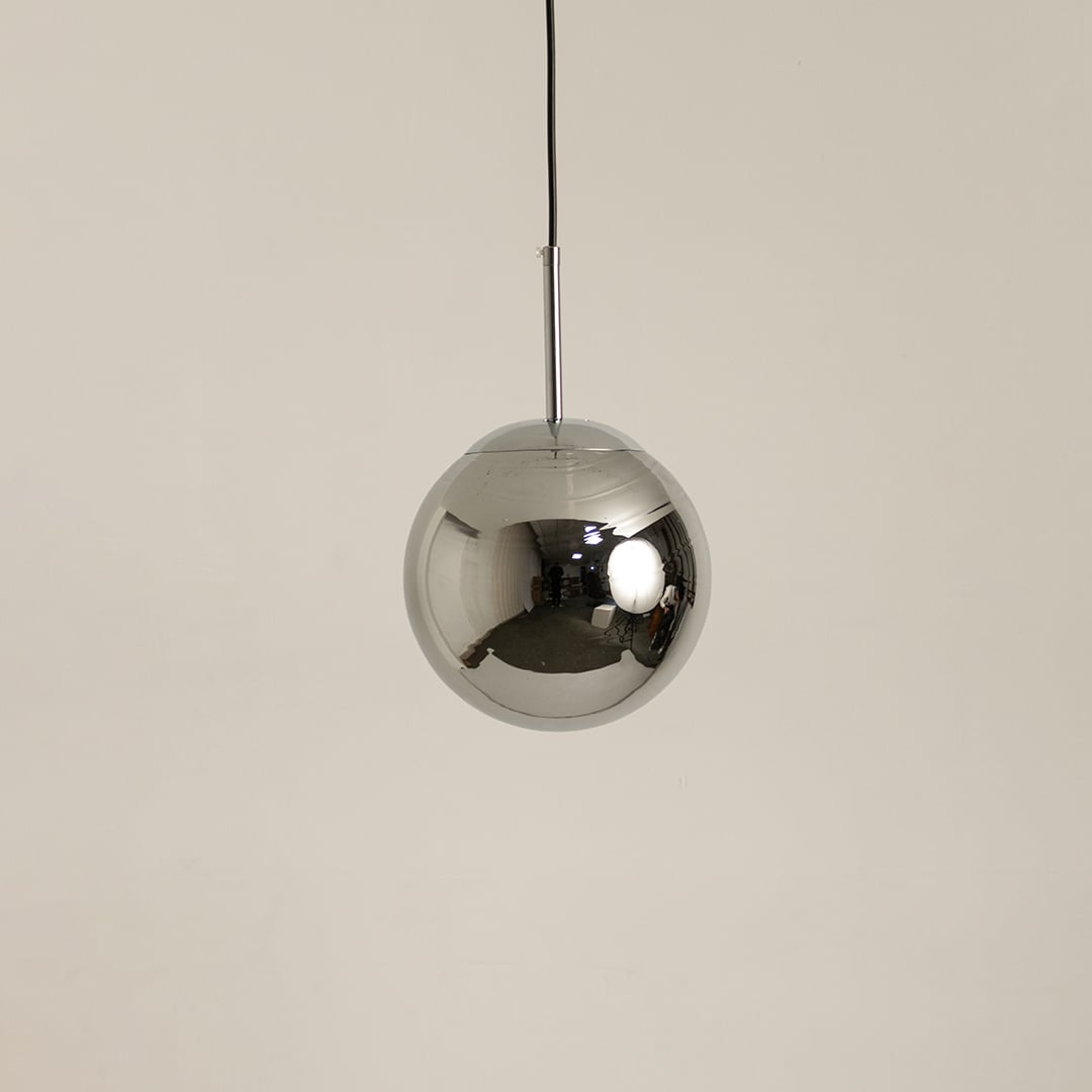 Chrome metal sphere pendant light shown off on a clean white background highlighting its reflective finish.