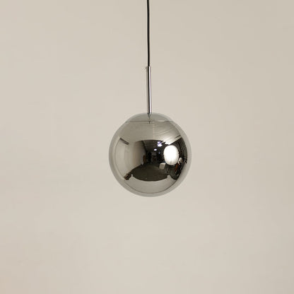 Chrome metal sphere pendant light shown off on a clean white background highlighting its reflective finish.