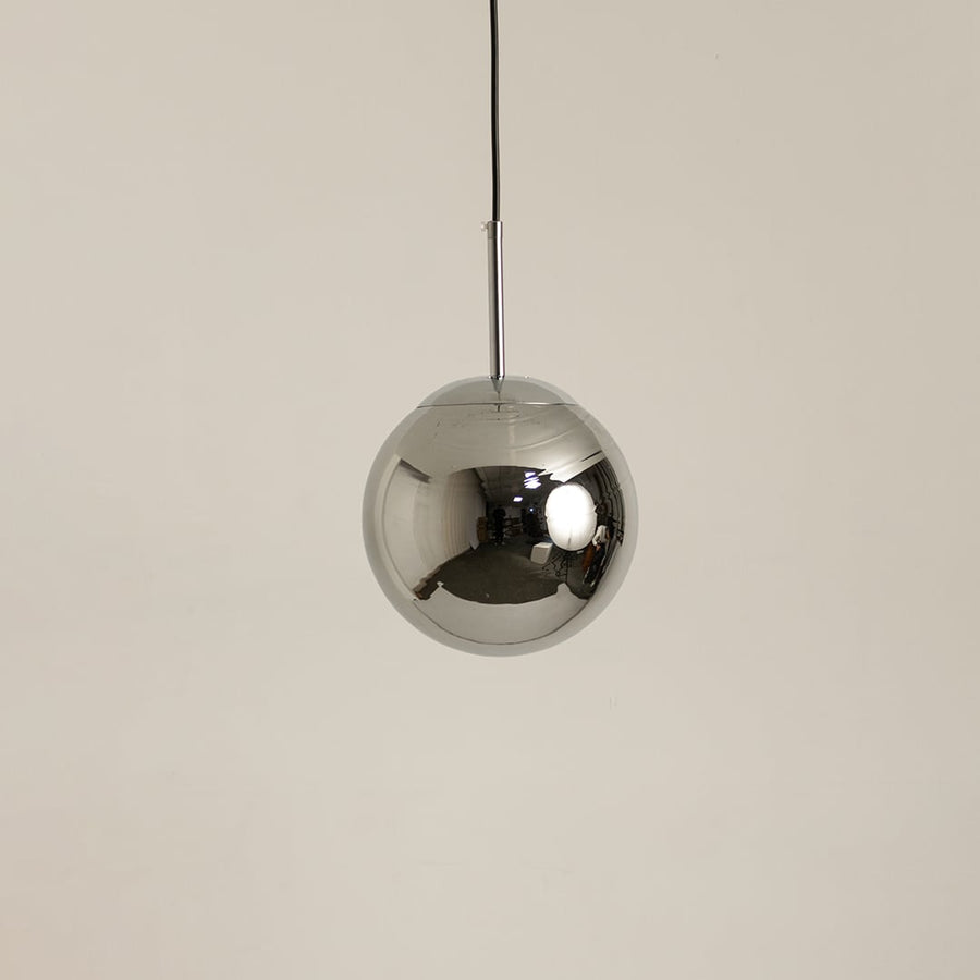 Chrome metal sphere pendant light shown off on a clean white background highlighting its reflective finish.