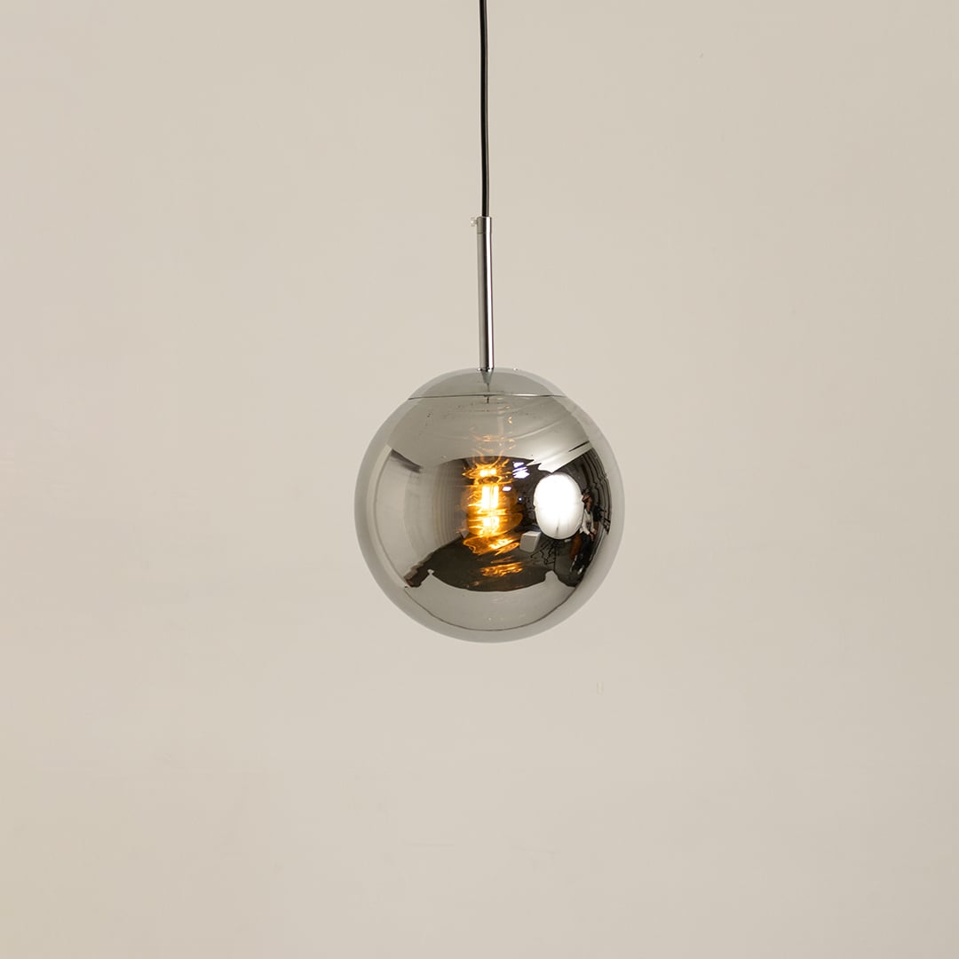 Chrome metal sphere pendant glowing softly on a white background for modern ceiling lighting decor.