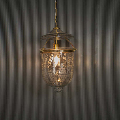 Antique brass and clear glass lantern pendant light adding timeless elegance to luxurious interiors.