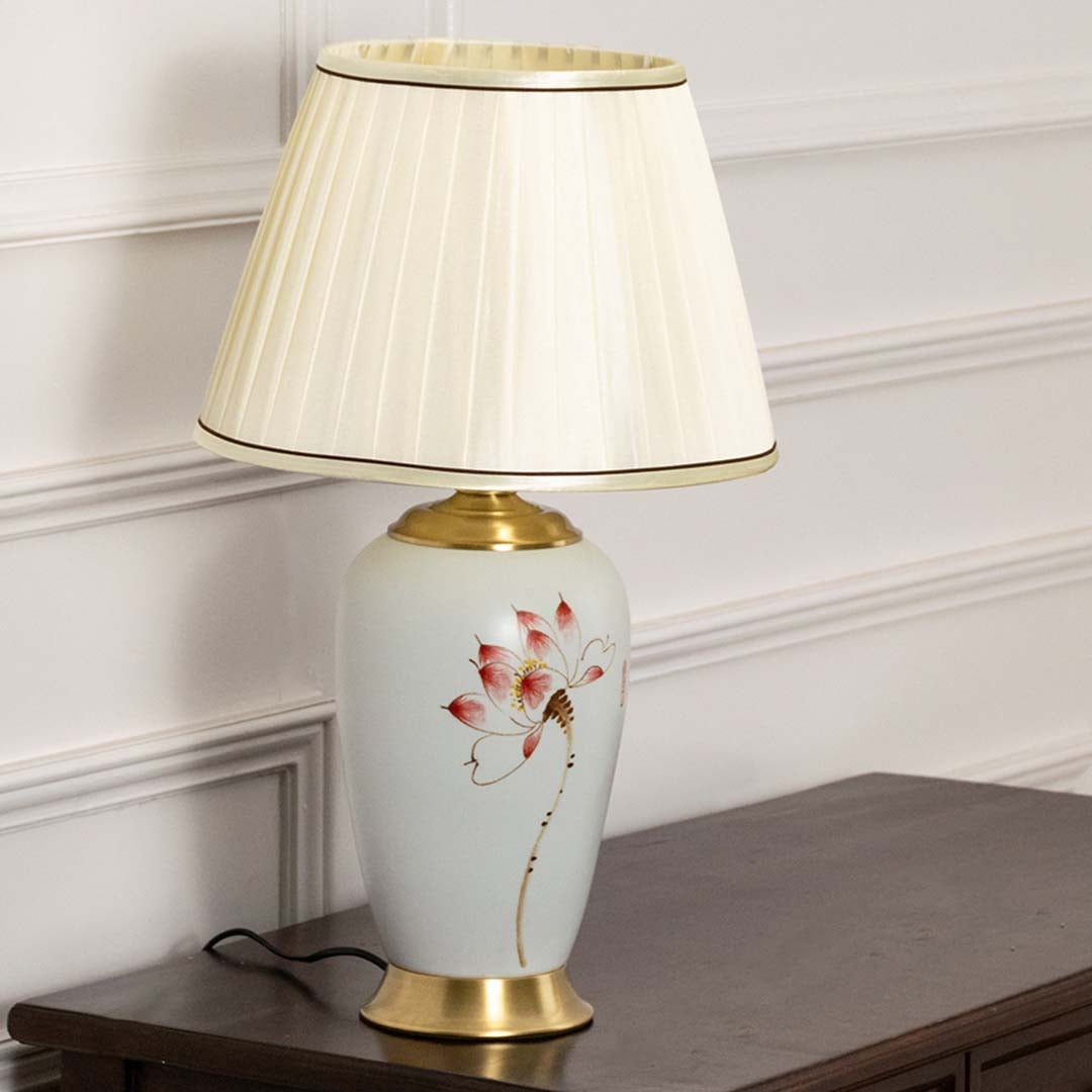 Unlit floral ceramic lamp with gold metal base and cream shade retains its decorative elegance and timeless beauty as a stylish decor piece.