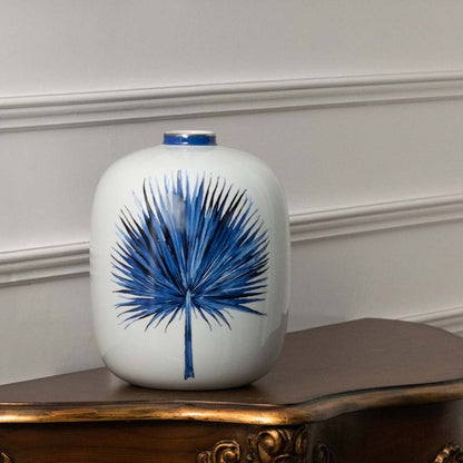 Blue and white ceramic jar with botanical leaf artwork perfect for minimalist décor adding refined handpainted beauty natural inspiration and calming artistic elegance to modern home styling.