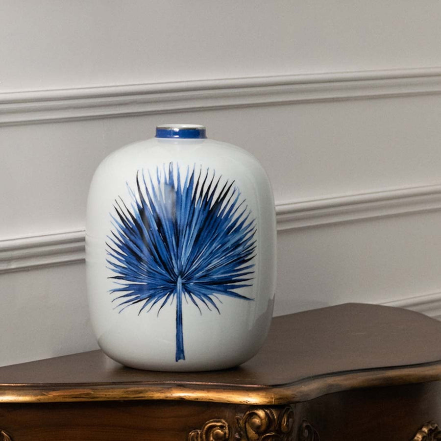 Blue and white ceramic jar with botanical leaf artwork perfect for minimalist décor adding refined handpainted beauty natural inspiration and calming artistic elegance to modern home styling.