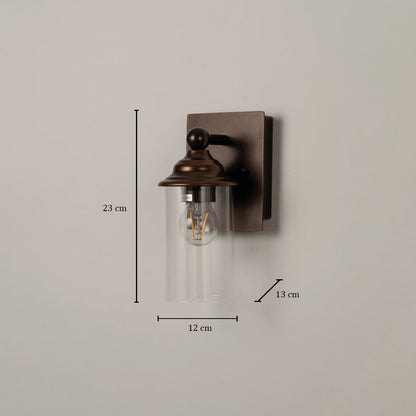 Bronze wall sconce with clear glass shade measuring 23 cm height 12 cm width and 13 cm depth for precise fitting.