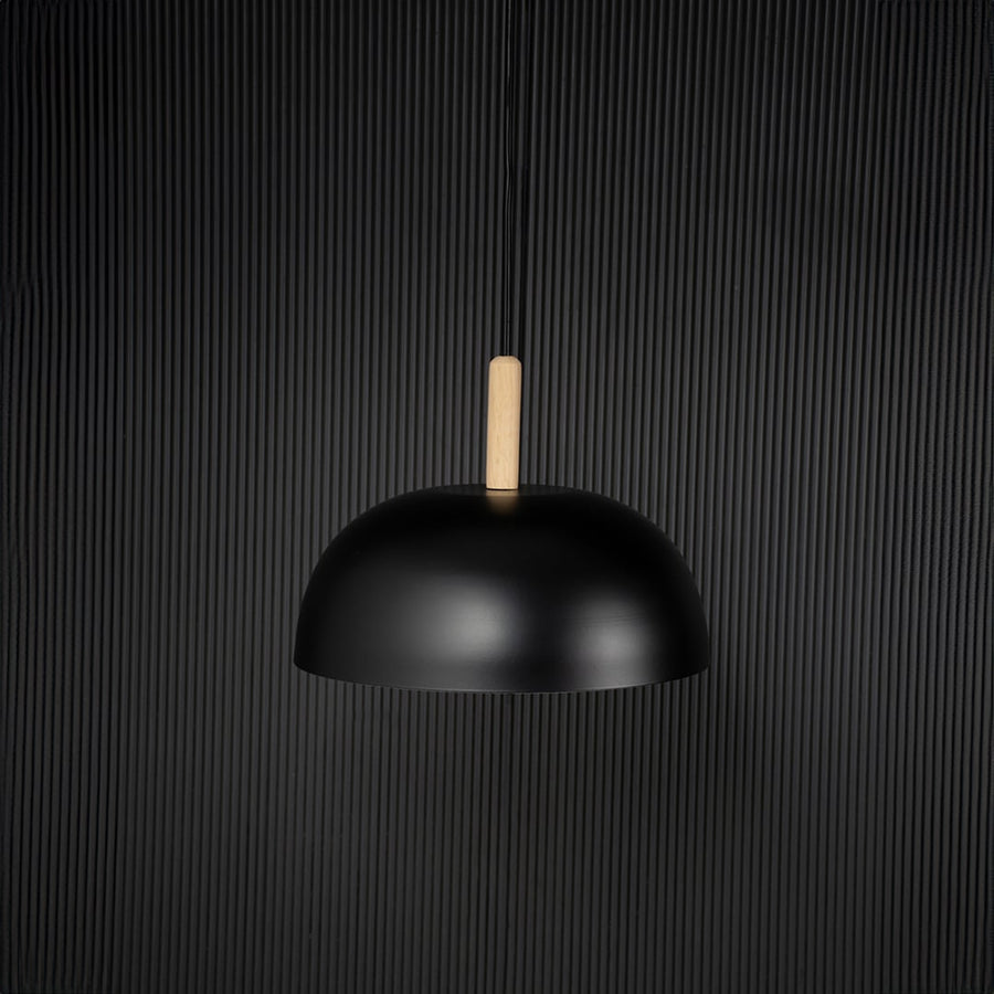Black dome pendant ceiling light with wood top switched off on back background for modern dining room cafe and home ceiling lighting decor.