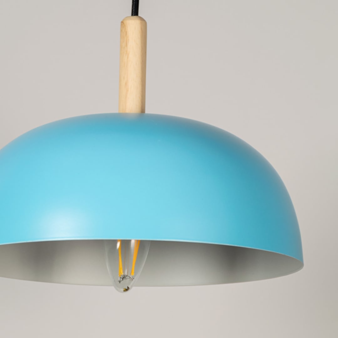 Closeup of blue pendant light with wooden accent and smooth dome shape creating sleek modern ceiling lighting.