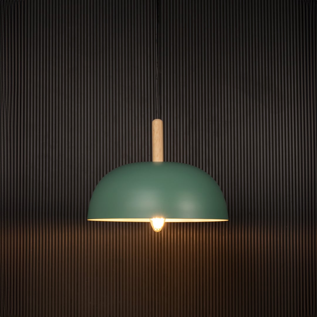 Green dome pendant ceiling light with wooden accent illuminated on back background for modern dining cafe and home interior ceiling lighting.