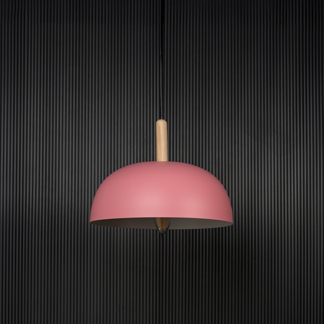 Pink dome pendant ceiling light with wood top switched off on back background for contemporary home dining and cafe interior lighting.