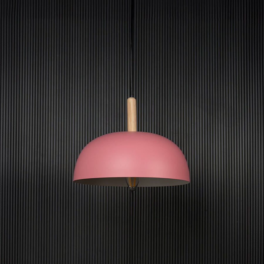 Pink dome pendant ceiling light with wood top switched off on back background for contemporary home dining and cafe interior lighting.