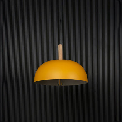 Yellow dome pendant light with wooden holder and bulb off on black background for a modern home lighting look.