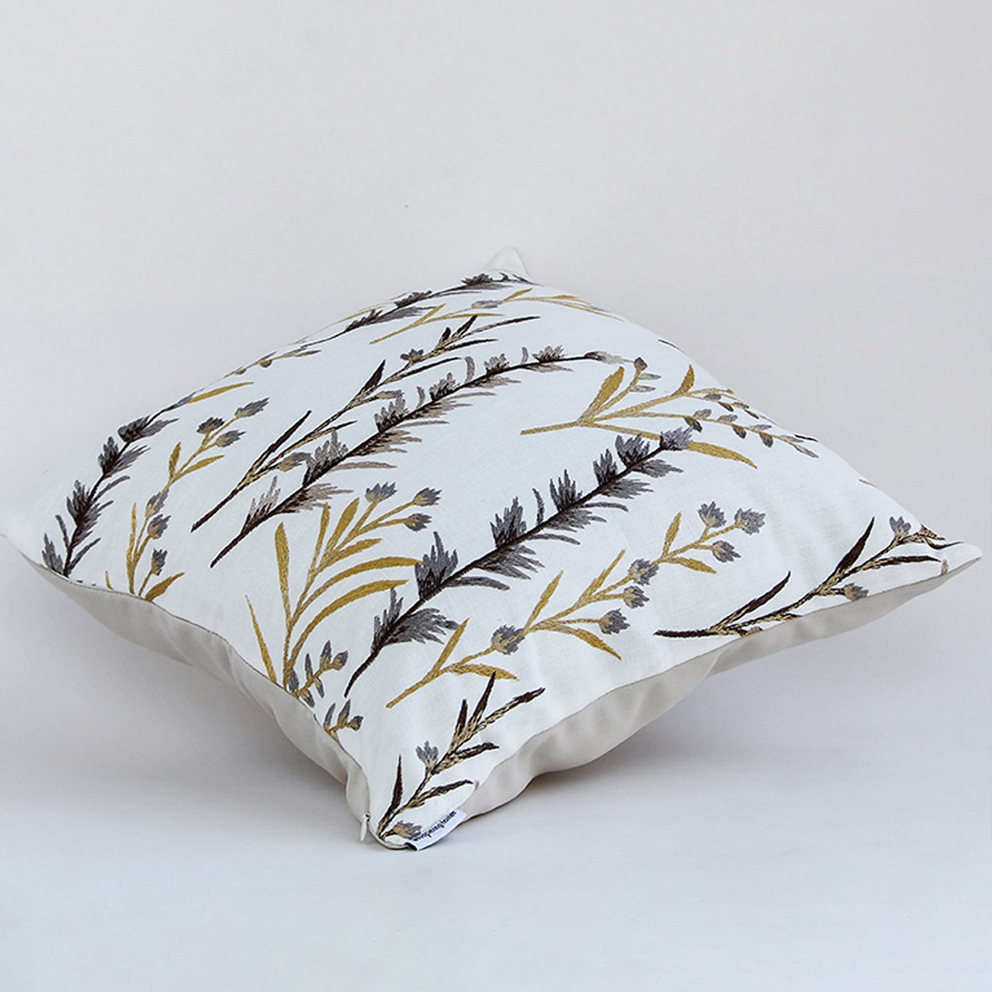 Cotton cushion with grey and yellow embroidered botanical design displayed on a white background showing detailed stitching ideal for home decor styling.