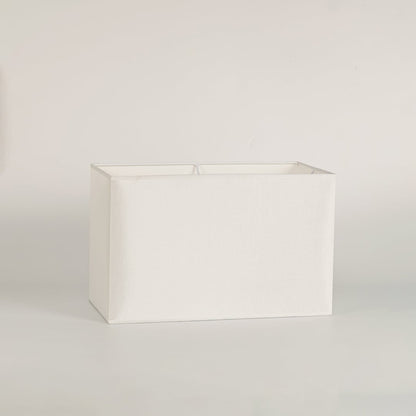 White rectangular lamp shade on plain background shown in close up view for modern minimal lighting décor.