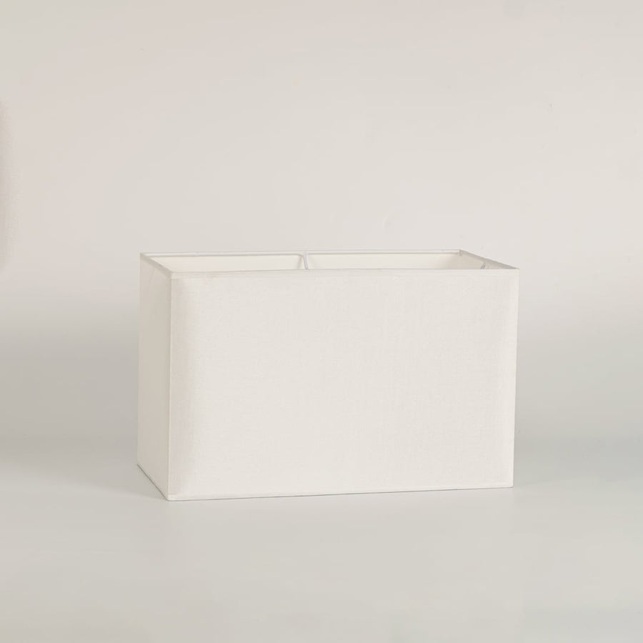 White rectangular lamp shade on plain background shown in close up view for modern minimal lighting décor.