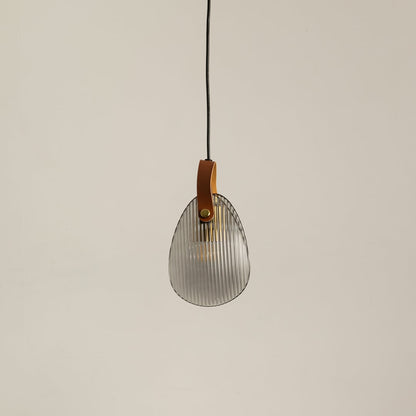 Ribbed glass pendant light with leather strap displayed off on a clean white background for minimalist lighting style.