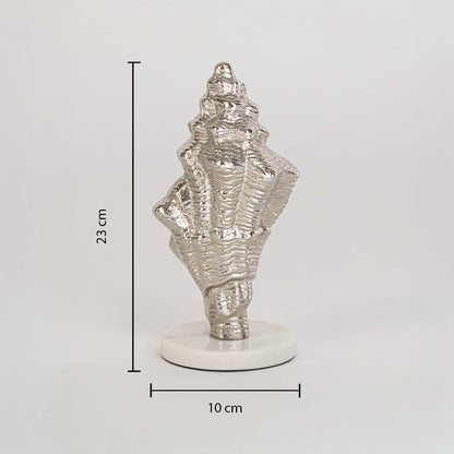 Decorative silver conch shell on white base measuring 23 cm high and 10 cm wide shown on clean white background