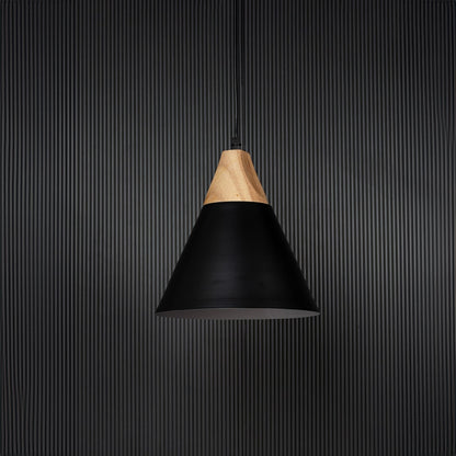Black pendant light with wooden top and metal shade shown off on black background for modern dining room lighting.