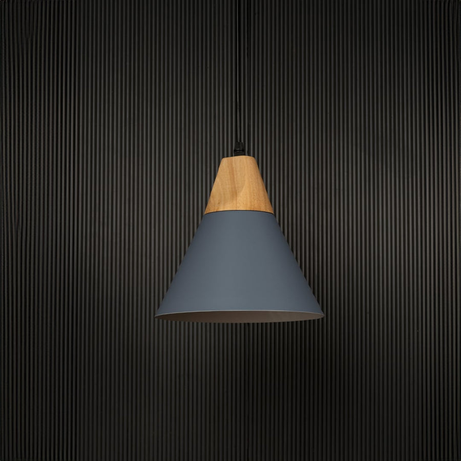 Blue pendant light with conical metal shade and wood accent shown off on black background for modern home lighting.