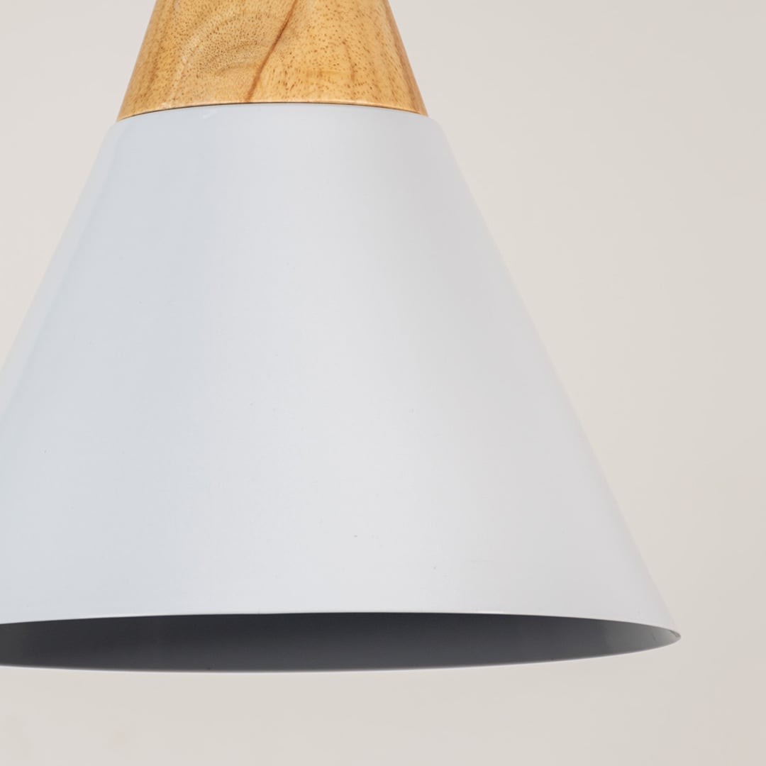 Closeup of white pendant light with wooden top and conical shade showing elegant detailing for modern home lighting.