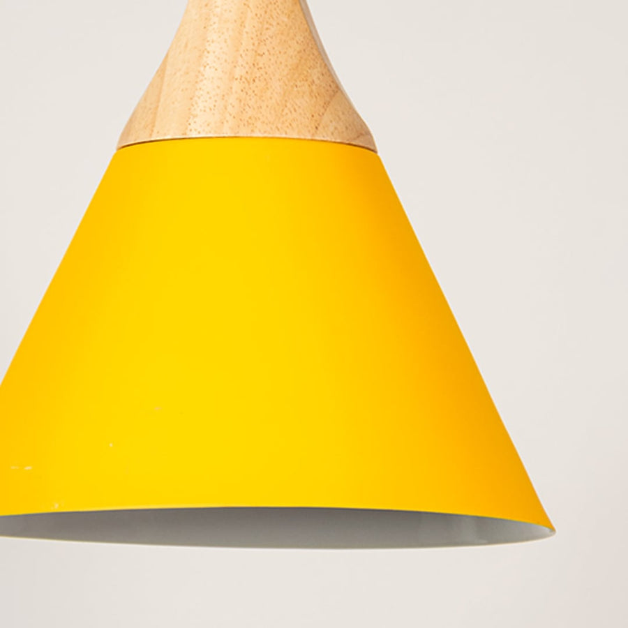 Closeup of yellow pendant light with wooden top and conical shade showing modern handcrafted lighting design.