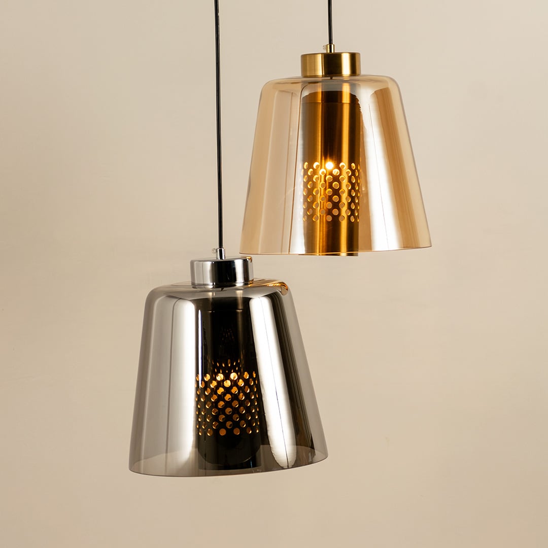 Grouped display of gold pendant light styled with decor pieces creating a modern warm ambience ideal for dining living and hallway spaces.