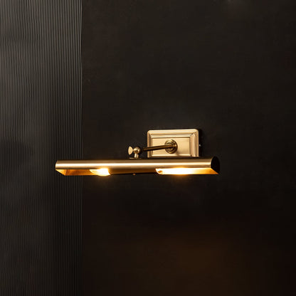 Gold metal picture light glowing warmly on a black background creating a dramatic accent lighting effect.