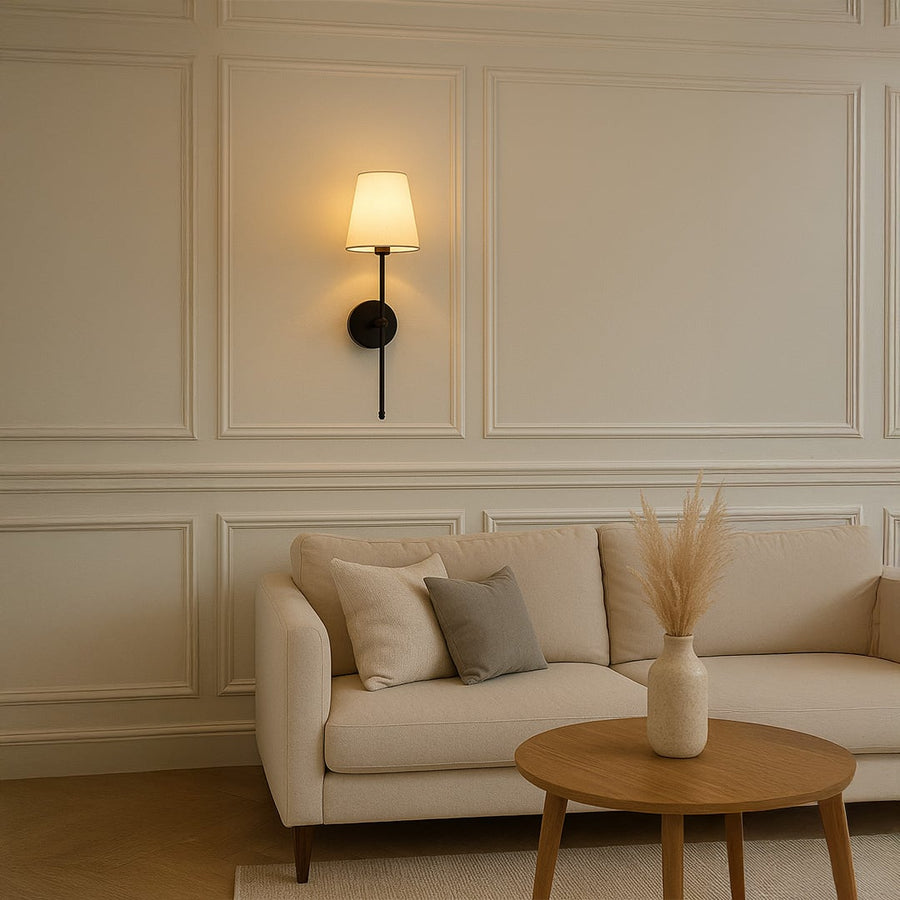 Black metal wall light with white fabric shade styled on a clean wall for modern home lighting decor.