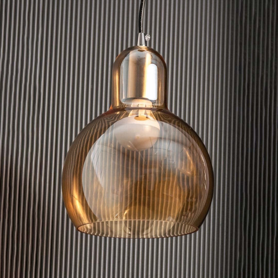Pendant light with amber glass shown against a black textured background with the light off highlighting the natural transparency and smooth finish.