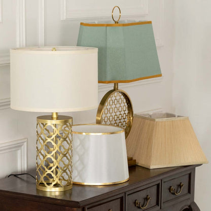 White shade gold lattice table lamp on wooden sideboard with light off for chic contemporary home décor.