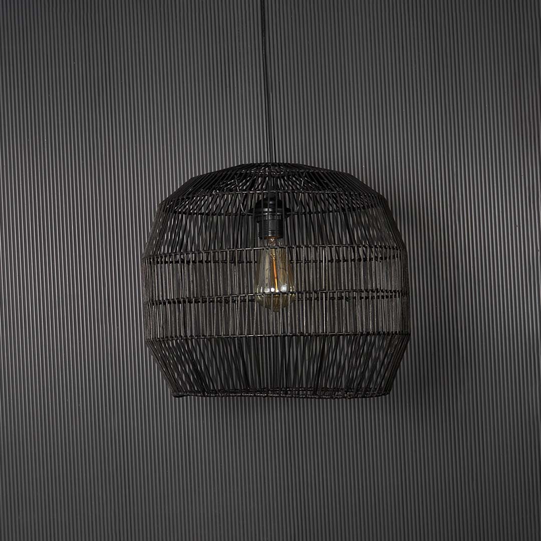 Contemporary black woven pendant light against black background featuring elegant handmade texture and sophisticated design appeal.