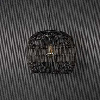 Contemporary black woven pendant light against black background featuring elegant handmade texture and sophisticated design appeal.