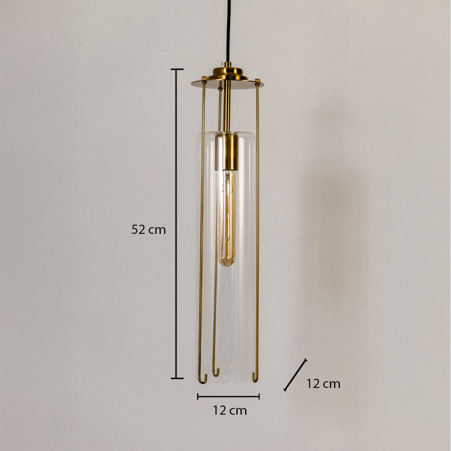 Clear glass pendant light with dimensions labeled 52 cm height and 12 cm width showing its slim cylindrical body and brass frame details.
