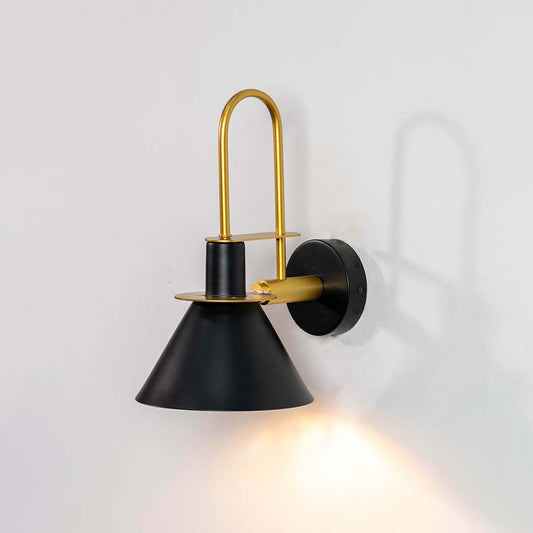 Modern black metal spotlight wall light with brass accents for elegant warm interior lighting decor.