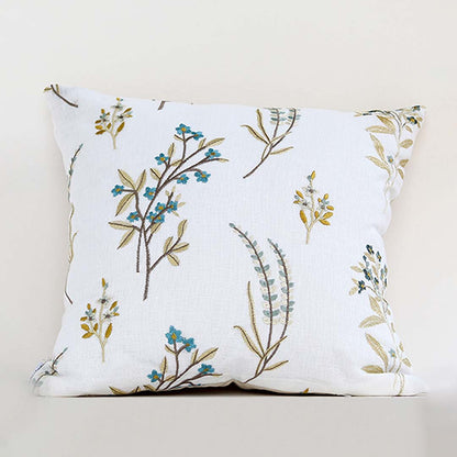 White cotton cushion cover with blue botanical floral print for sofa bedroom seating and elegant home decor styling.