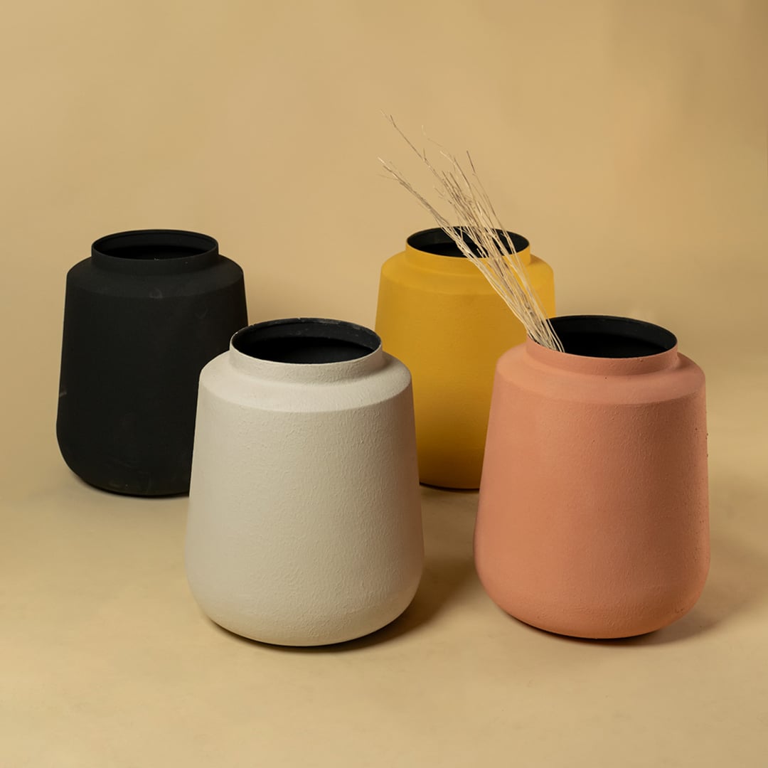 Black metal decorative vases displayed together for modern home styling adding bold texture to shelves and consoles.