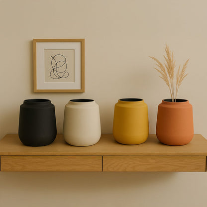 Terracotta metal textured vase styled with matching decor pieces creating a warm earthy accent for modern living spaces.