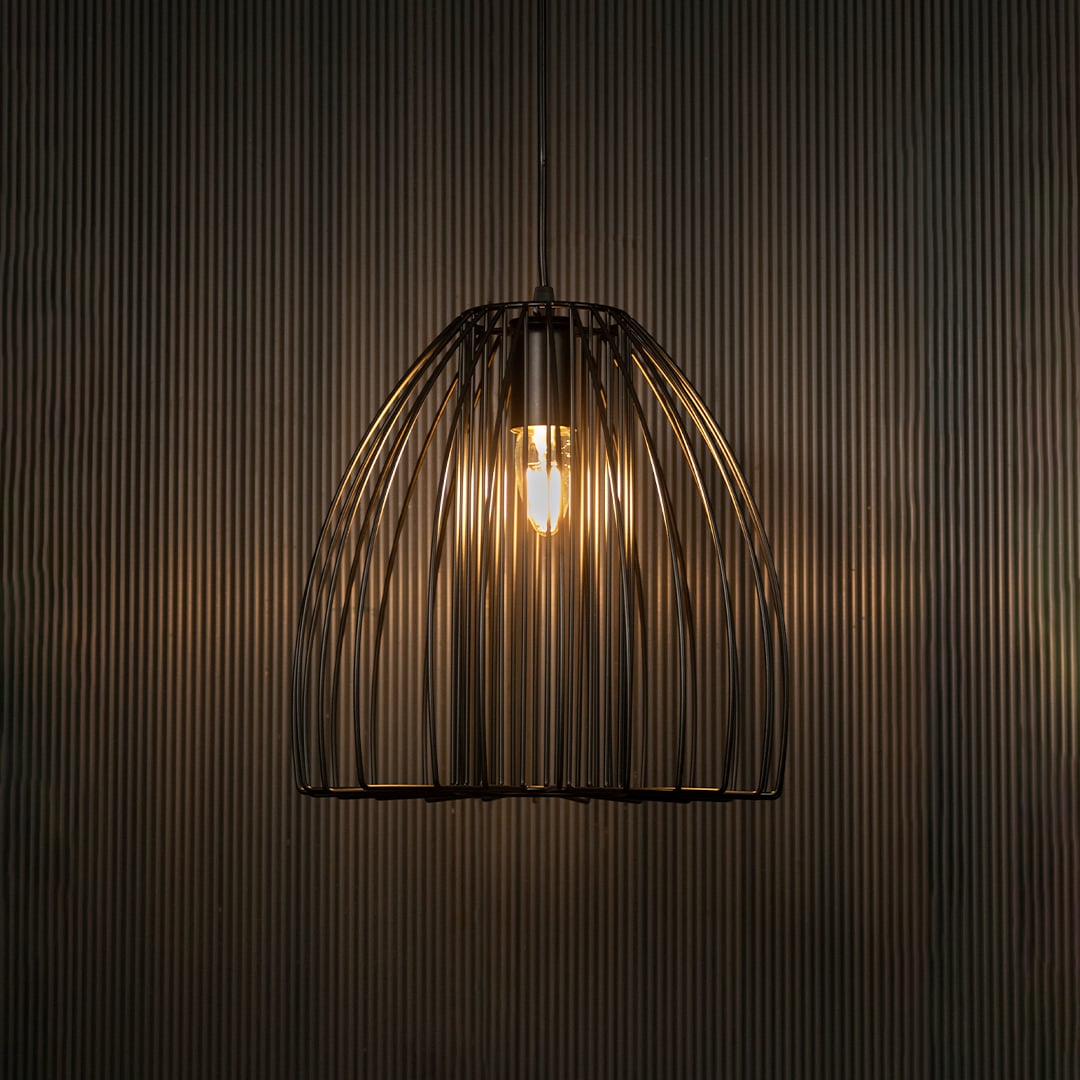Elegant black cage pendant light illuminated on dark background highlighting artistic industrial design and warm modern lighting.