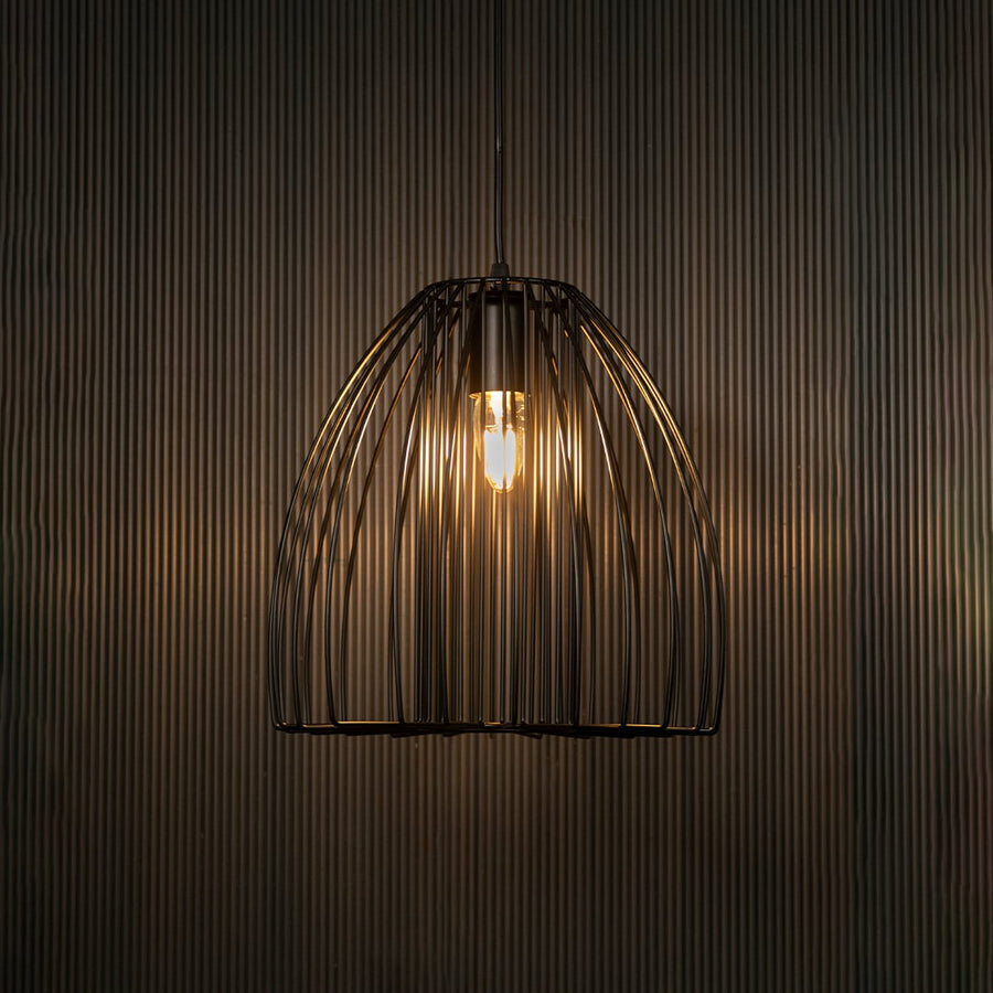 Elegant black cage pendant light illuminated on dark background highlighting artistic industrial design and warm modern lighting.