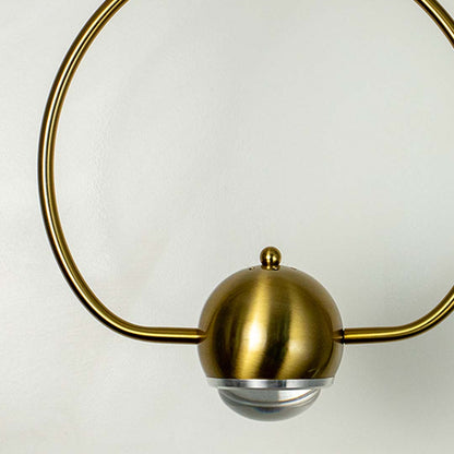 Elegant brass gold wall lamp with round frame and frosted globe shade crafted in metal for modern living and bedroom decor.